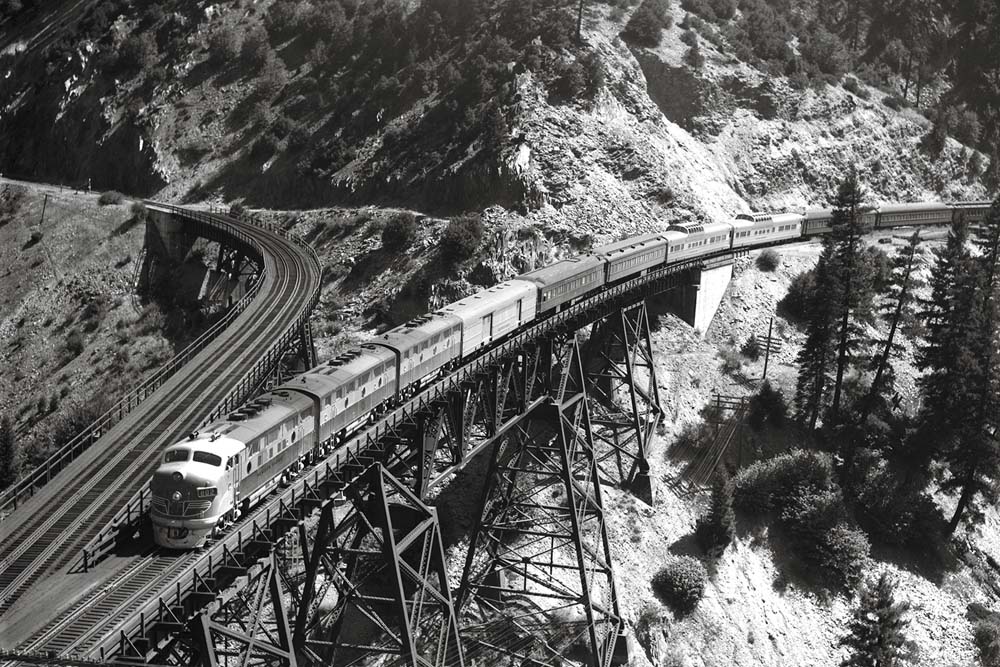 Streamlined and heavyweight passenger train on steel trestle