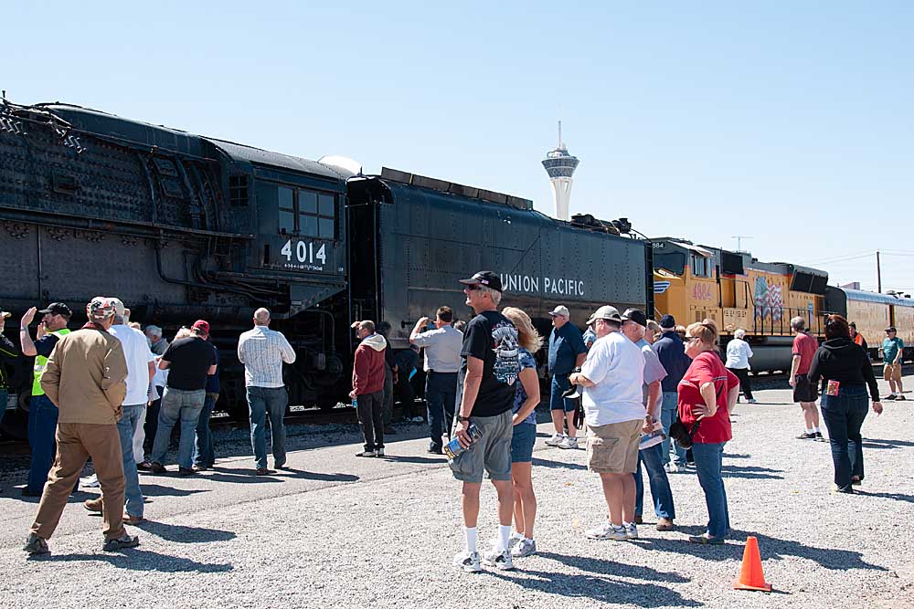 People look at steam locomotive on display