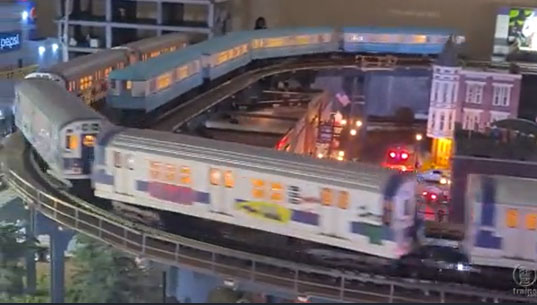 Subway cars racing by on an O gauge layout.