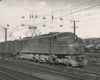 Black-and-white three-quarter-angle photo of streamlined electric locomotive.