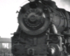 Black-and-white photo of front portion of 4-6-2 steam locomotive.