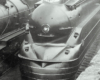 Black-and-white photo of front portion of 4-6-2 steam locomotive.