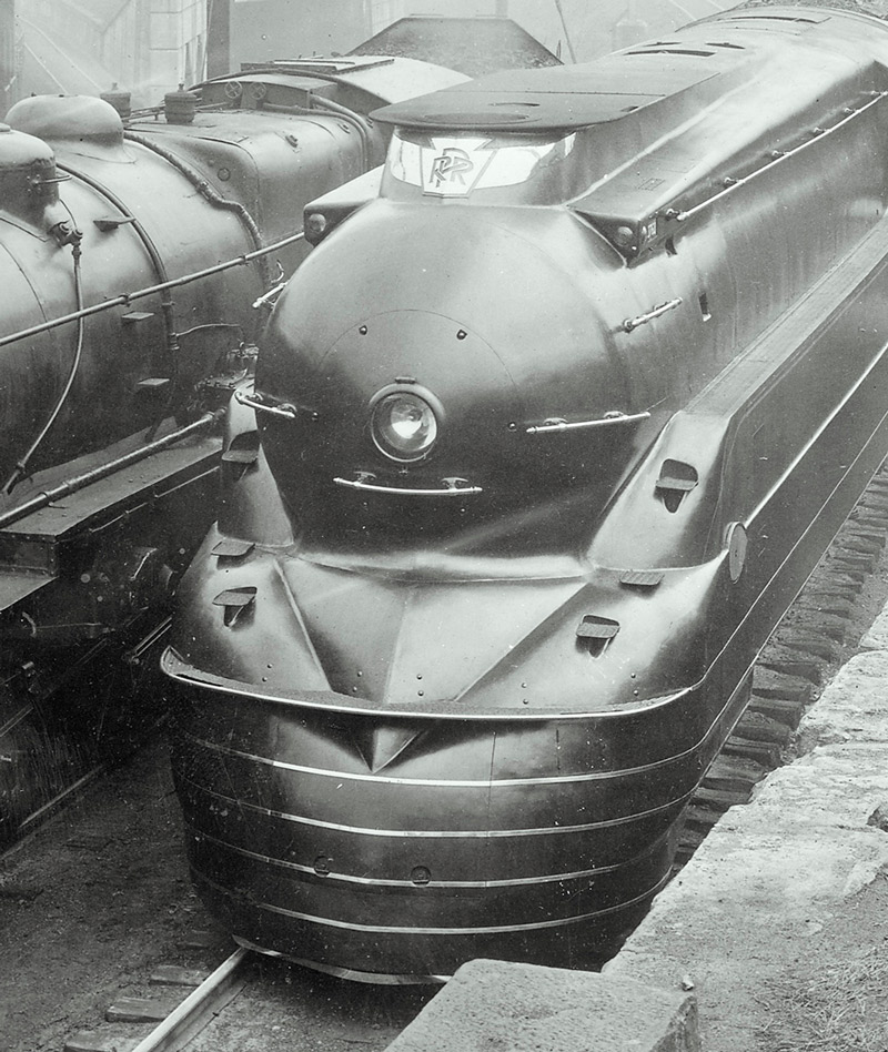 Black-and-white photo of front portion of 4-6-2 steam locomotive.