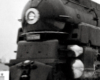 Black-and-white photo of front portion of 4-6-2 steam locomotive.