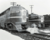 Black-and-white photo of the noses of two streamlined diesel locomotives.