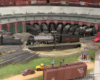 photographer standing on top of a boxcar shoots a portrait of Canadian Pacific steam locomotives lined up at a roundhouse