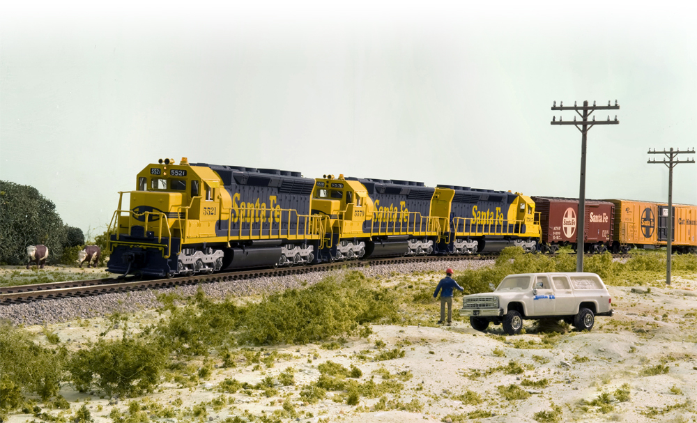Model train scene with vehicle and scale figure