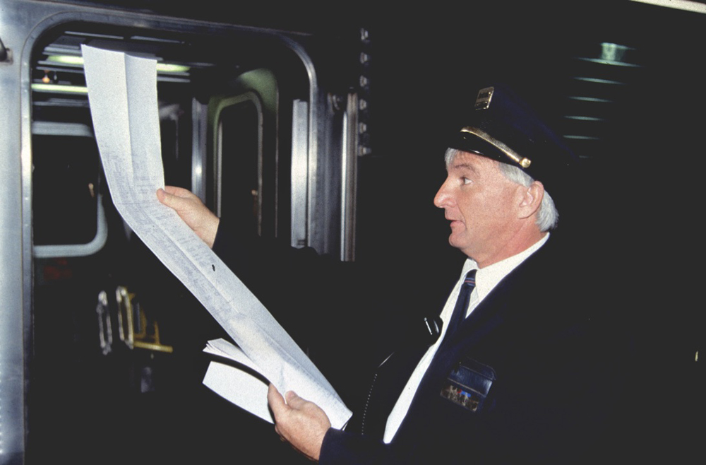 Amtrak employee looking at long computer printout