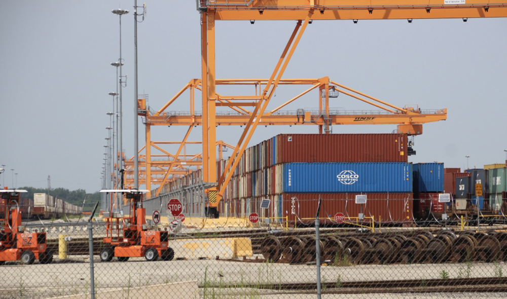 Containers stacked under cranes