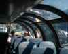 Two men sitting in glass dome of passenger car