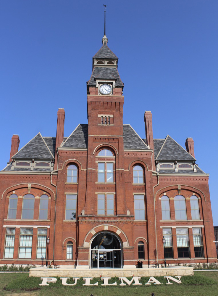 Multi-story brick building with center clock tower