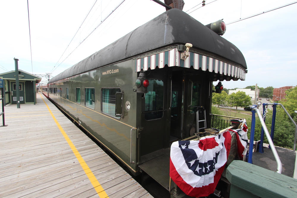 Green heavyweight passenger car with rear platform