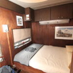 Wood-paneled bedroom with large bed