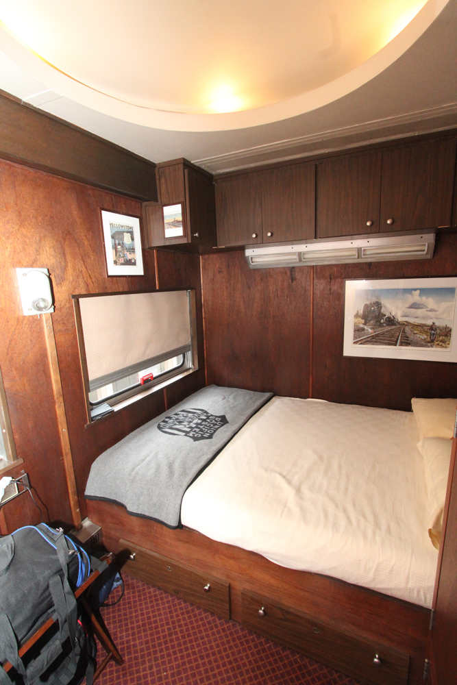 Wood-paneled bedroom with large bed