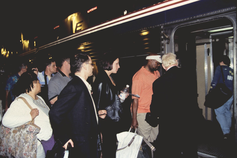 Crowd of people boarding passenger car