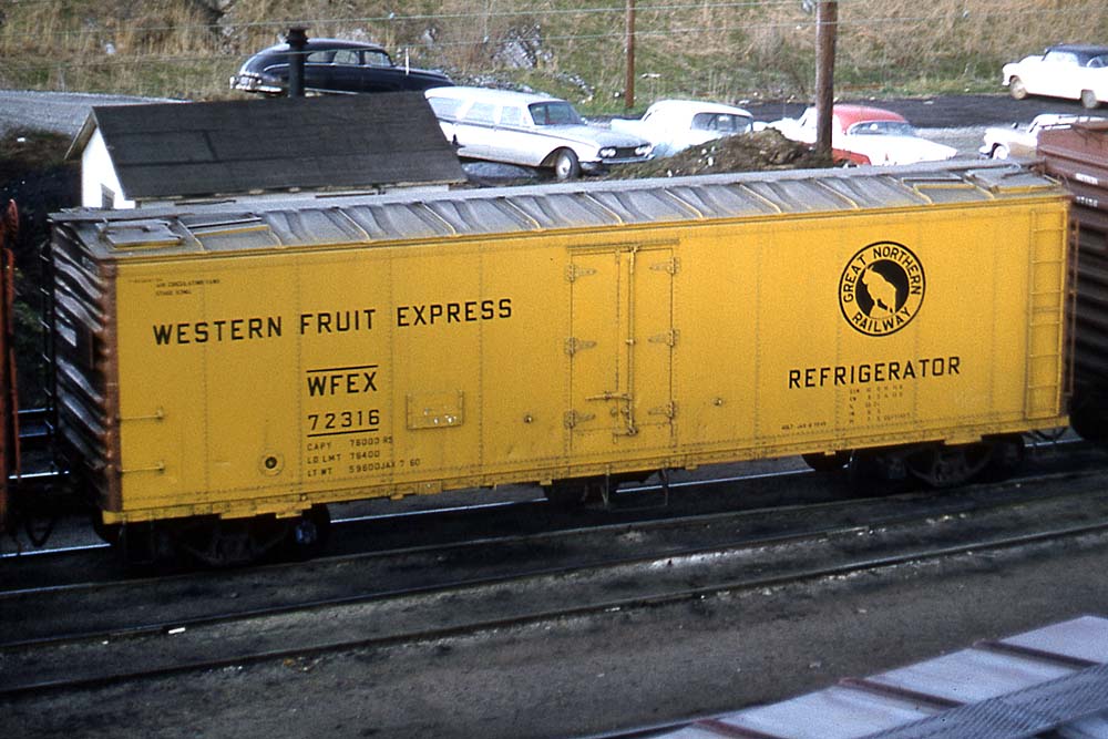Yellow ice-cooled refrigerator car with silver roof and brown ends