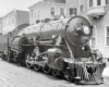 Black-and-white three-quarter right-side photo of 4-6-2 steam locomotive at rest