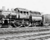 Black-and-white left-side photo of Camelback 4-4-2 steam locomotive at rest