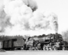 Black-and-white right-side photo of 2-8-8-0 steam locomotive in action
