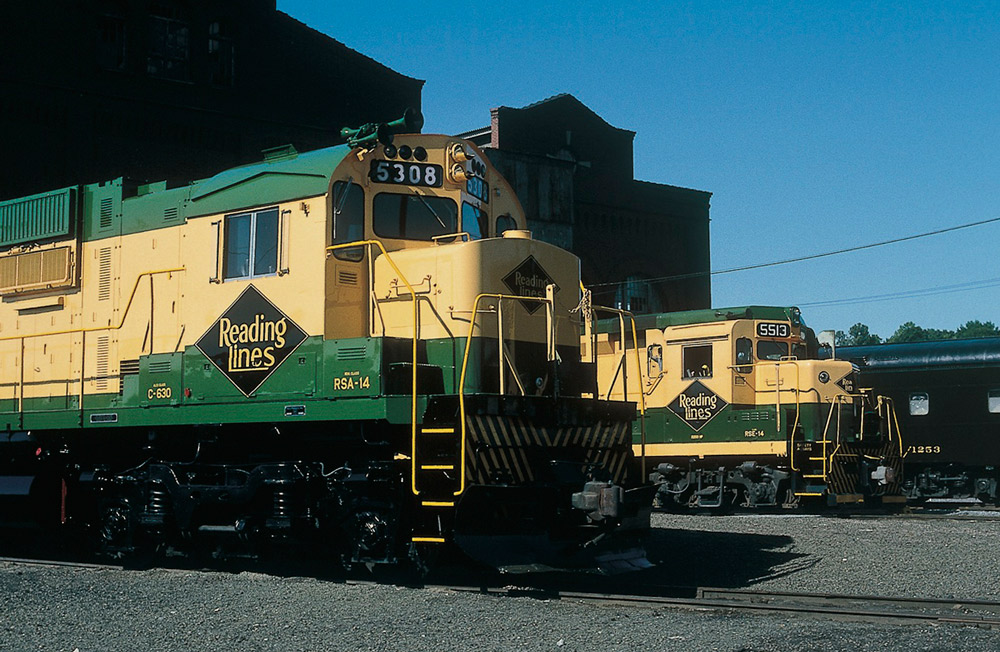 Color photo of side-by-side noses of two road-switcher diesel locomotives