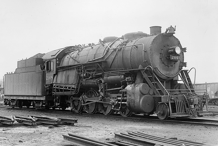 Black-and-white three-quarter left-side photo of 2-8-0 steam locomotive at rest