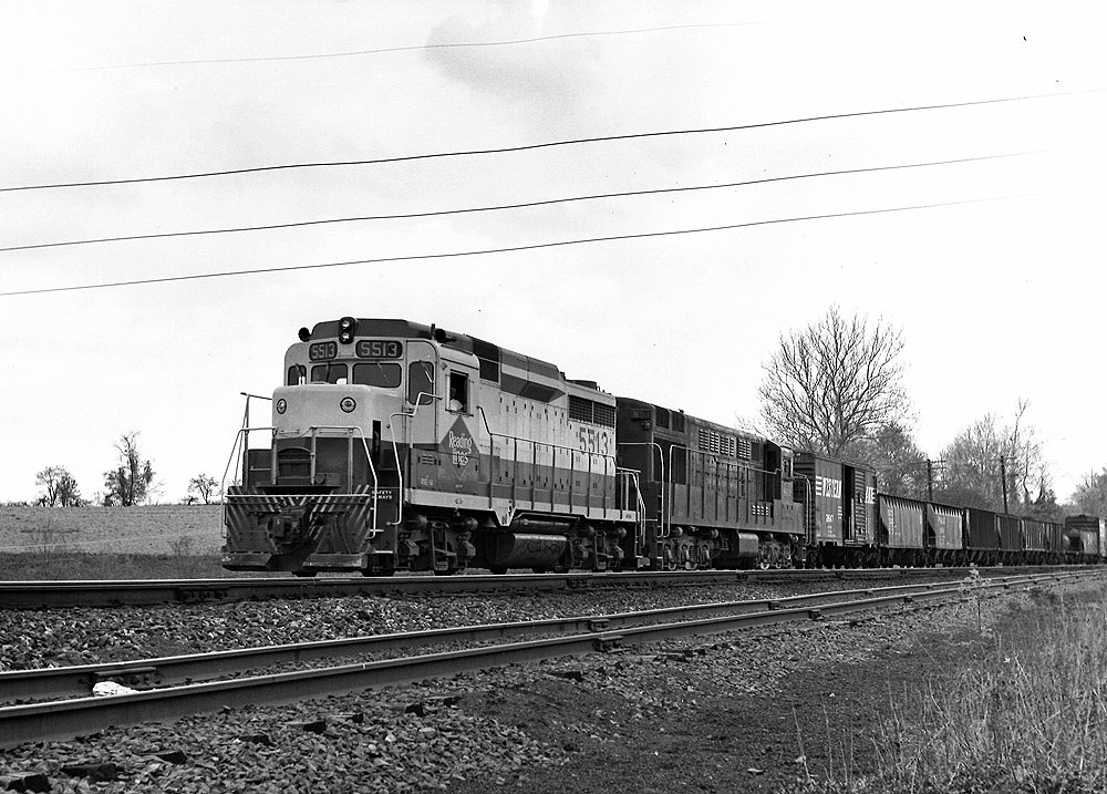 Black-and-white photo of two road-switcher diesel locomotives with Reading Company freight train
