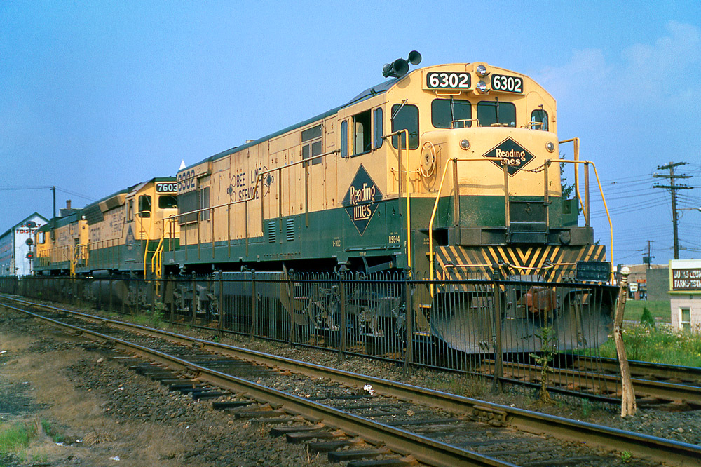 Color three-quarter-angle photo of three road-switcher diesel locomotives
