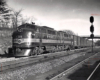 Black-and-white photo of two streamlined diesel locomotives with Reading Company freight train