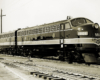 Black-and-white three-quarter-angle photo of two streamlined diesel locomotives