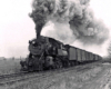 Black-and-white photo of steam locomotive with Reading Company freight train