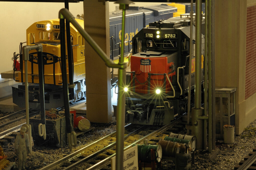 A Santa Fe and a Union Pacific locomotive in a railroad shop setting.