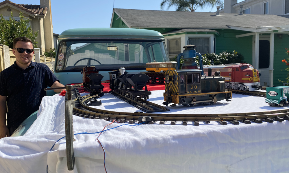 Man standing next to a layout in a pick up truck