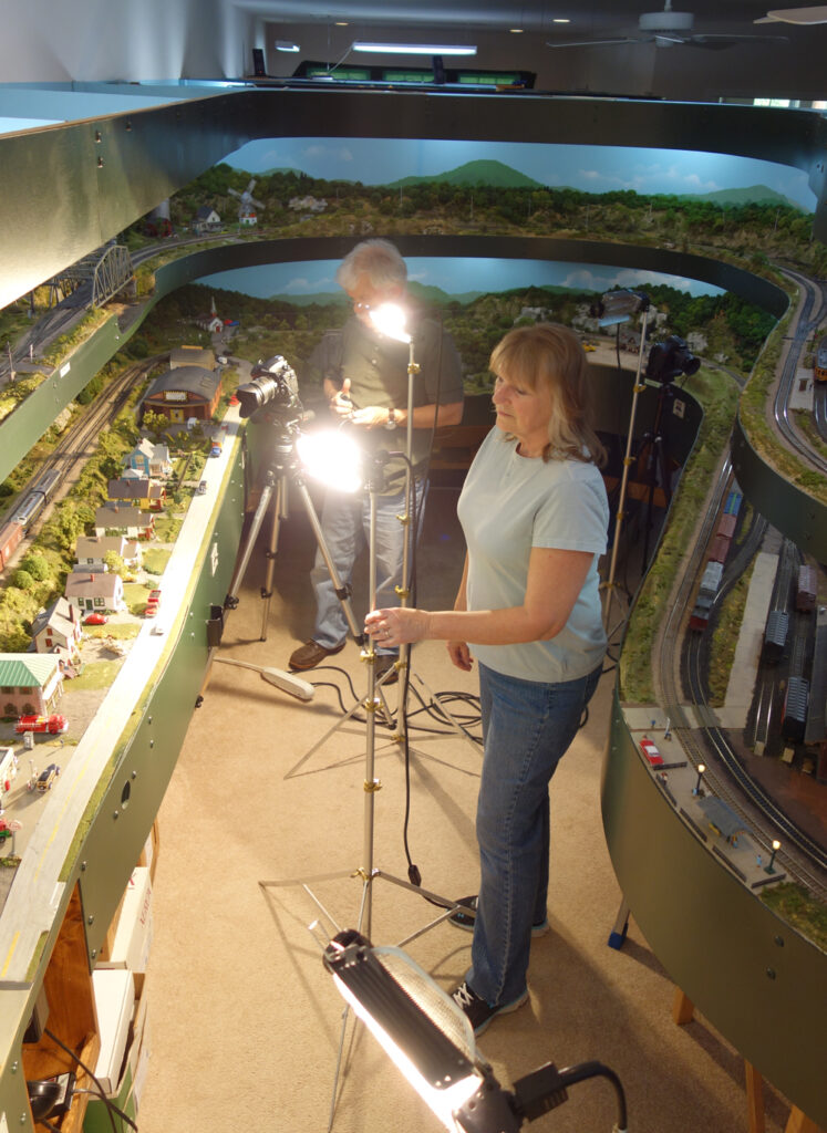 Man and woman setting up photo equipment