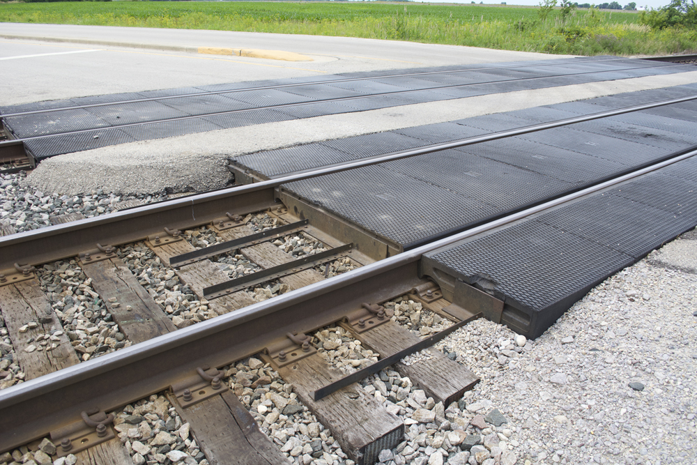 Freshly installed rubber mat grade crossings on double-track mainline.