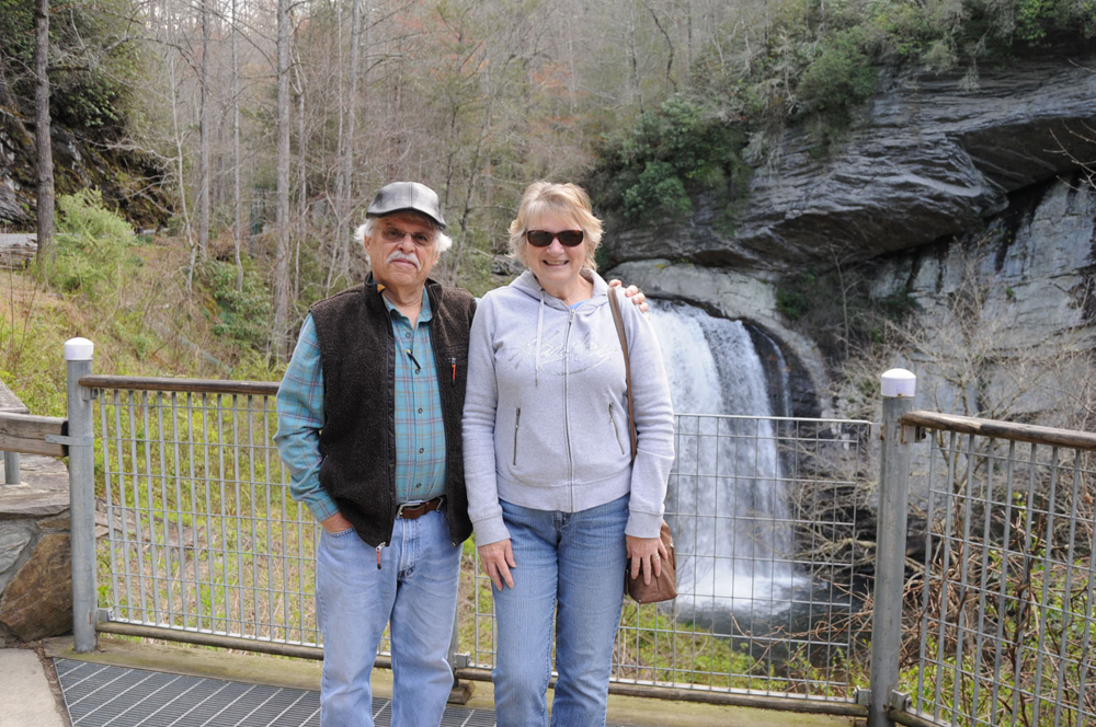 Man and woman next to small waterfall