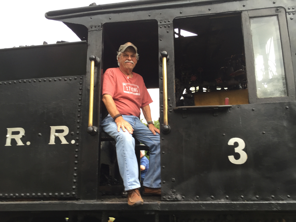 Man in cab of steam locomotive
