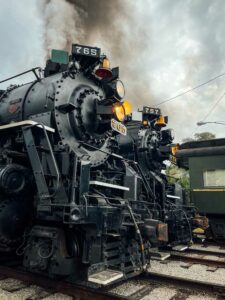 Two steam locomotives lined up side-by-side