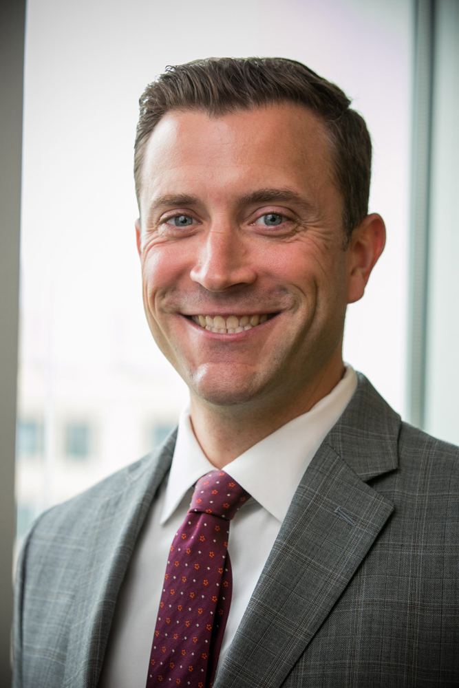 Smiling man in coat and tie