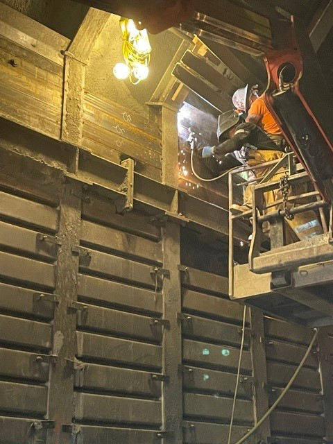 Worker on lift inside tunnel