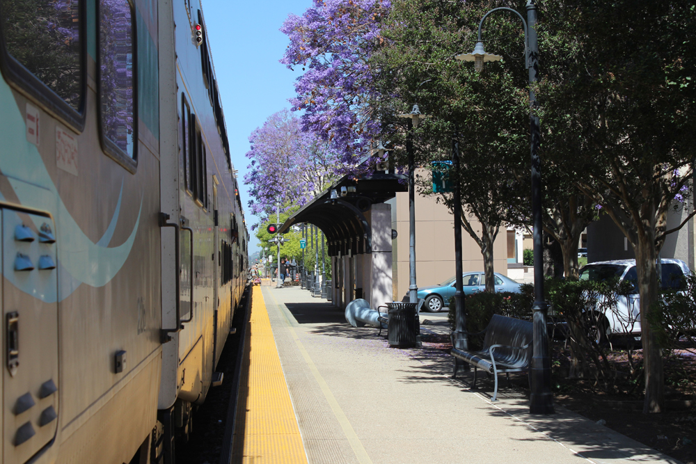 As seen from onboard train, commuter train stops at station