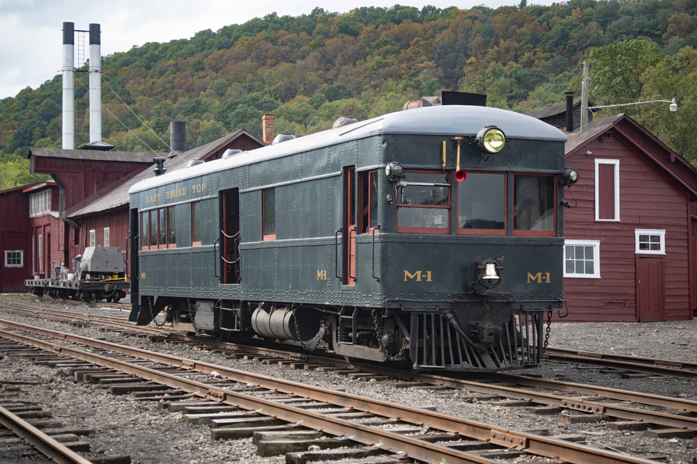 Green motorcar near station