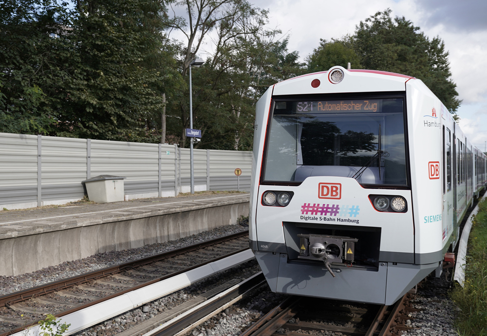 White commuter train with no engineer in cab