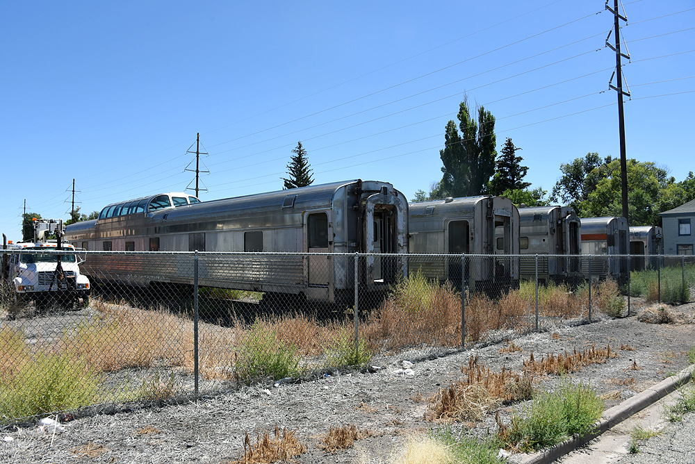 Passenger cars in a grass-covered field.