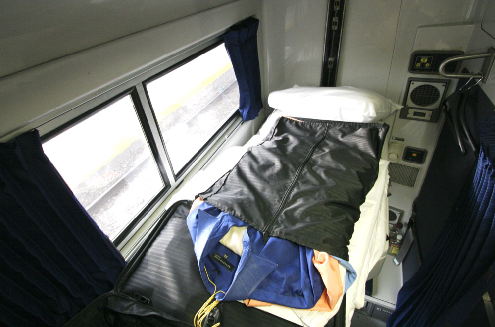 Clothing bag on folded-down bed in sleeping car