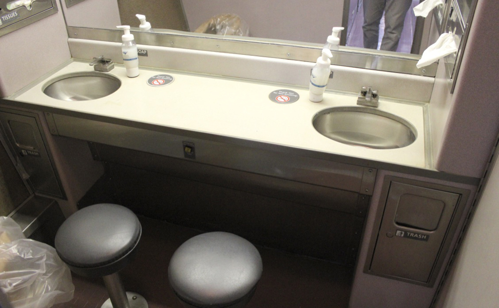 Restroom space with sinks and stools on Superliner passenger car