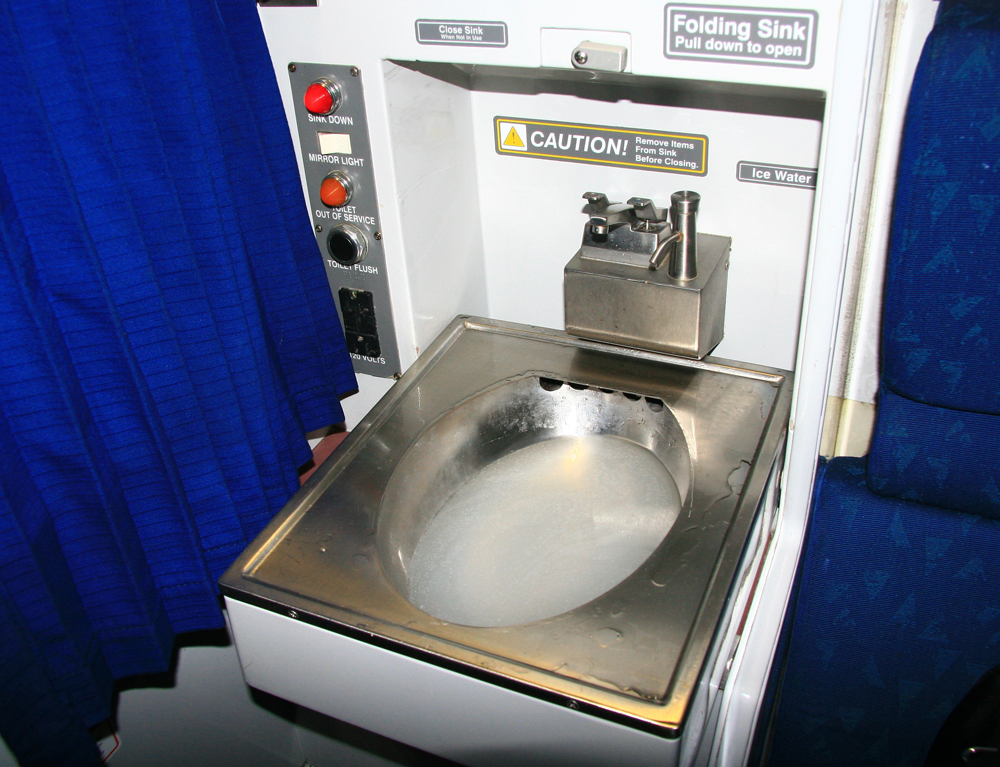 Fold-down roomette sink, nearly full of soapy water