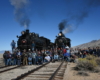 60 people gather around two steam locomotives to celebrate locomotive No. 81’s return and Trains Magazine’s 81st anniversary