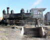 A 4-6-0 steam locomotive poses over a pit.