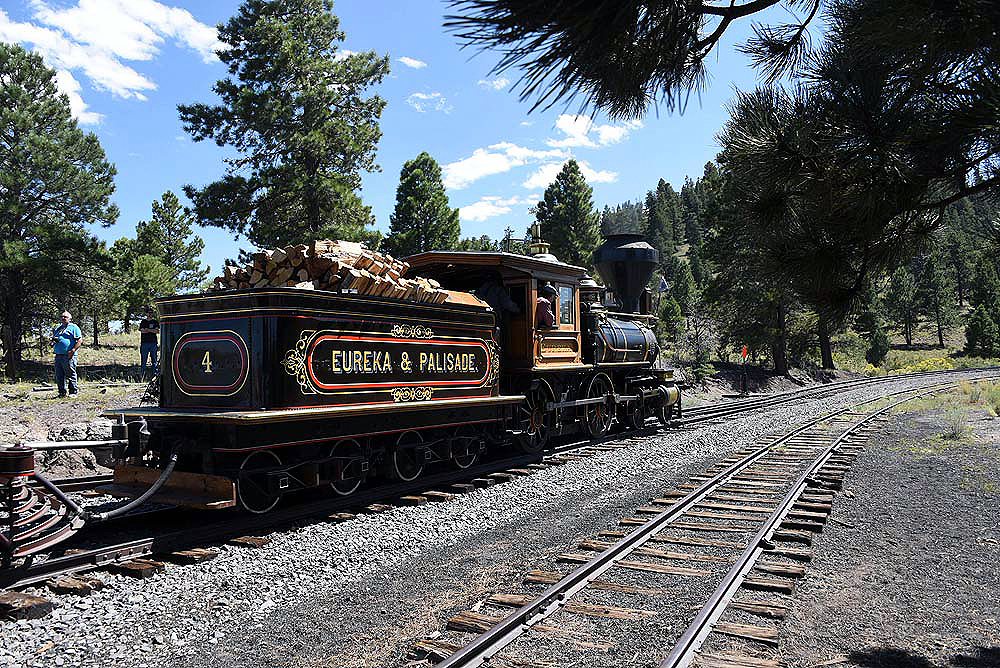 Rear view of a 4-4-0 wood-fired locomotive.