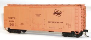 An orange HO scale insulated boxcar model on a white backdrop